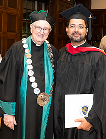 St. Mary's President-Rector, Rev. Phillip J. Brown, P.S.S. with a 2022 graduate.
