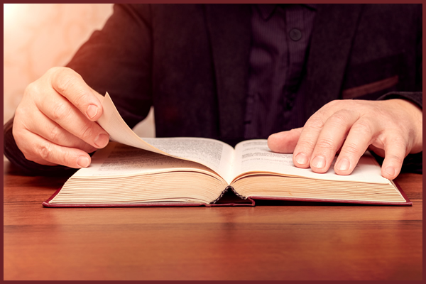 Priest-formator with Bible/book.